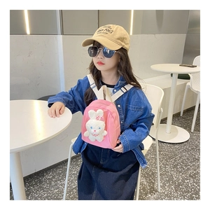 Detailed shot of pink canvas toddler backpack featuring a cute 3D plush bunny doll