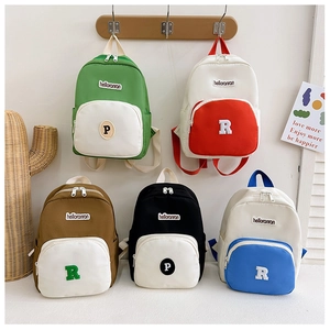 Five assorted color-block canvas mini backpacks for kids featuring letter patches