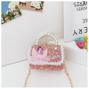 Close-up of pink sequined girls mini bag with pearl handle and Love charm detail