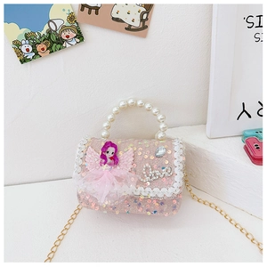 Detail of pink sequin girl's bag with pearl handle and cartoon doll ornament