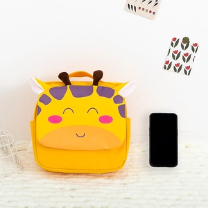 Detail view of mini giraffe backpack for toddlers with 3D ears and phone for scale