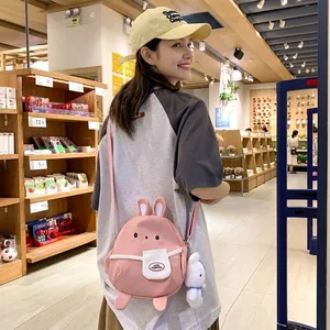 Pink cartoon rabbit canvas shoulder bag for women with plush bunny pendant charm