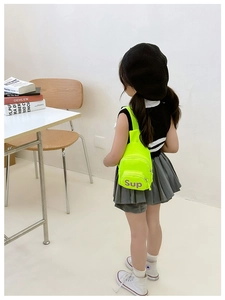 Detailed view of neon yellow kids chest bag with purple lettering and zipper closure