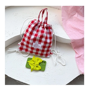 Detail of red and white checkered canvas mini drawstring backpack for children