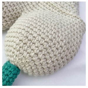 Detailed macro view of cream and teal hand-crocheted yarn texture with tight stitching