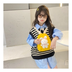 Detail of a bright yellow canvas toddler backpack featuring a cute 3D plush rabbit doll