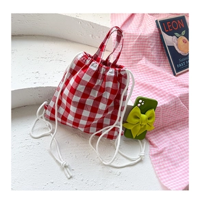 Detail of red and white gingham kids backpack with cotton drawstring and carry handle
