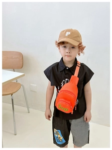 Close-up of bright orange canvas sling bag for kids with adjustable strap and Sup logo