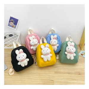 Detailed display of mini canvas backpacks with plush bunny dolls in five vibrant colors
