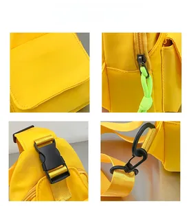 Detail of yellow kids canvas bag with Trend logo, durable zippers and adjustable buckles