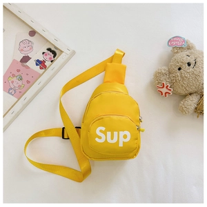 Detail view of bright yellow kids chest bag with Sup logo and adjustable black strap