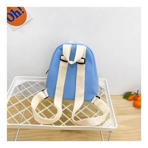 Detail of light blue canvas toddler backpack with wide adjustable shoulder straps