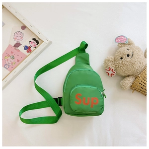 Detailed close-up of a green nylon kids chest bag with orange Sup lettering