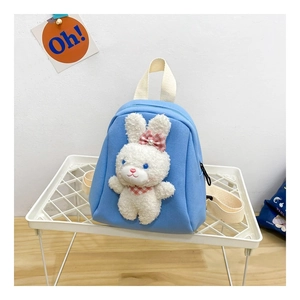 Detail of light blue toddler backpack featuring a white plush bunny with checkered scarf