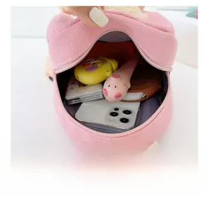 Detail view of the pink canvas mini backpack interior showing capacity for small items