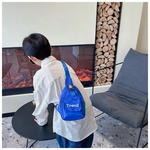 Blue nylon kids chest bag with Trend logo and neon green zipper puller detail