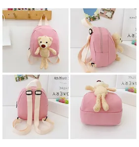 Four-angle views of a pink canvas toddler backpack featuring a plush bear doll attachment