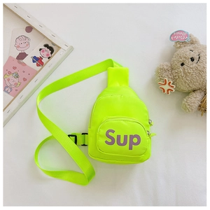 Detail view of neon green kids sling bag with purple Sup logo and adjustable strap