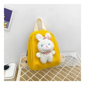 Detail of yellow canvas kids backpack with a cute 3D plush bunny and adjustable straps