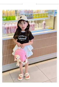 Pink canvas toddler backpack with a cute plush bear accessory worn by a child