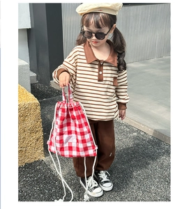 Close-up of red and white plaid drawstring canvas bag as a stylish kids accessory