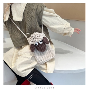 Close-up of handmade crochet lamb crossbody bag with cute eyes for girls