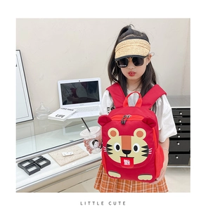 Detail of cute red cartoon tiger backpack with Fu character on soft canvas fabric