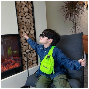 Close-up of kids neon green nylon chest bag with Trend print for stylish streetwear look