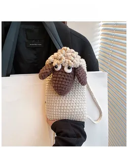 Detail view of handmade crochet sheep crossbody bag with knit strap and wool textures