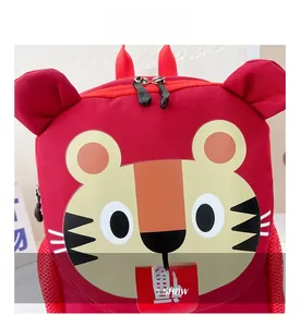 Close-up of cute red tiger backpack for kids with 3D ears and durable fabric detail