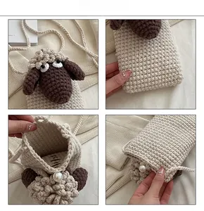 Detail of handmade knit lamb crossbody bag featuring a pearl clasp and crochet texture
