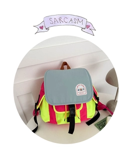 Detail of multi-color canvas backpack with bear patch and adjustable strap buckle