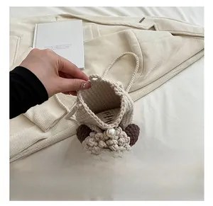 Detail view of the spacious inner compartment of this beige handmade crochet mini bag