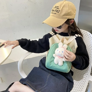 Cute mint green canvas children's backpack featuring a 3D plush bunny doll and straps