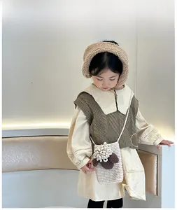 Detail view of handmade knitted crossbody bag for girls featuring a 3D sheep decoration