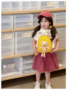 Close-up of yellow canvas kids backpack featuring a cute 3D plush bear and adjustable straps