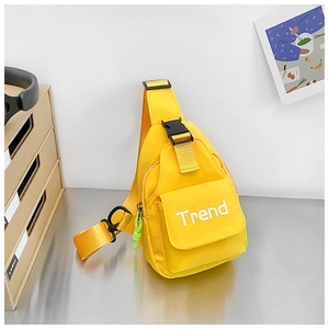 Close-up of a yellow nylon chest bag for kids featuring a Trend letter print and front flap