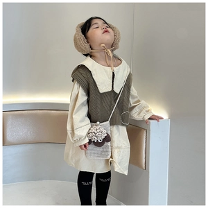 Detail of handmade knit crossbody bag for kids with cute 3D sheep design and pearl button