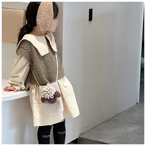 Detail of handmade knit lamb crossbody bag for girls styled with autumn winter outfit