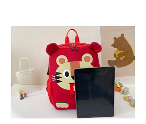 Detailed size comparison of a red cartoon tiger kids backpack next to a tablet device