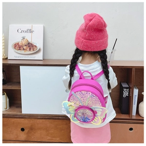 Détail du sac à dos rose à paillettes avec motif Elsa porté par un enfant mannequin