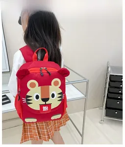 Detailed close-up of a red cartoon tiger toddler backpack with lucky character detail