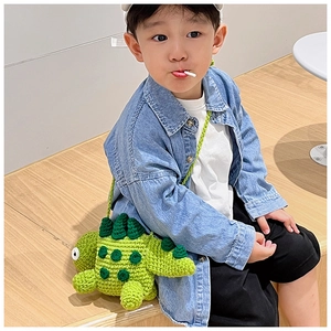 Kids wearing a green handmade crochet dinosaur crossbody bag with cute knitted details