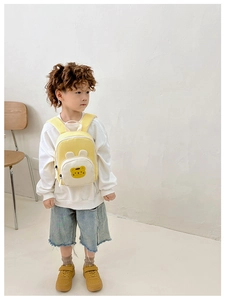 Modèle enfant portant un sac à dos en toile jaune et blanc avec de mignonnes oreilles