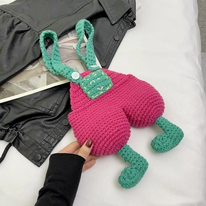 Handmade crochet overall style crossbody bag in vibrant pink and green knitted wool