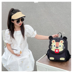 Detail of cute tiger cartoon kids backpack with festive Fu character on a white storage box