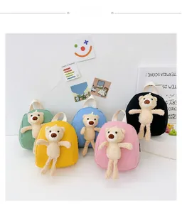 Detail shot of five colorful mini canvas backpacks featuring 3D plush teddy bear dolls