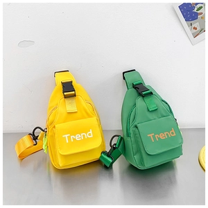 Detail view of yellow and green nylon kids chest bags with Trend letter logo printing