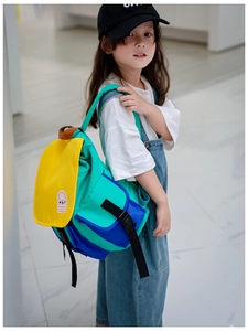 Detailed view of kids color-block canvas backpack with durable nylon fabric and secure flap