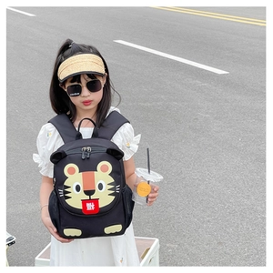Detail of cute tiger backpack featuring a traditional fortune character and mesh side pockets